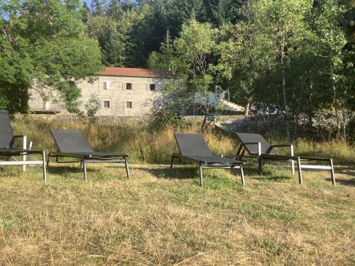 a group of chairs sitting in the grass at Maison en Ardeche in Usclades