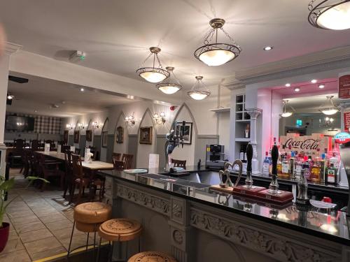 a bar in a restaurant with tables and chairs at The Bell Shifnal in Shifnal