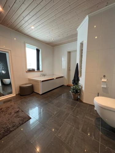 a large bathroom with a tub and a sink at Villa Gratangen in Gratangen