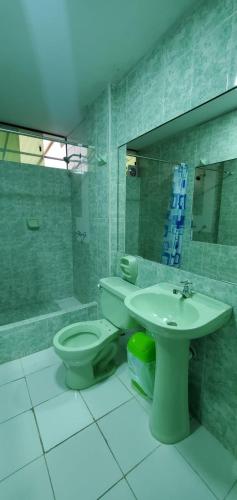 a bathroom with a toilet and a sink at Hospedaje El Paraiso in Santa Eulalia