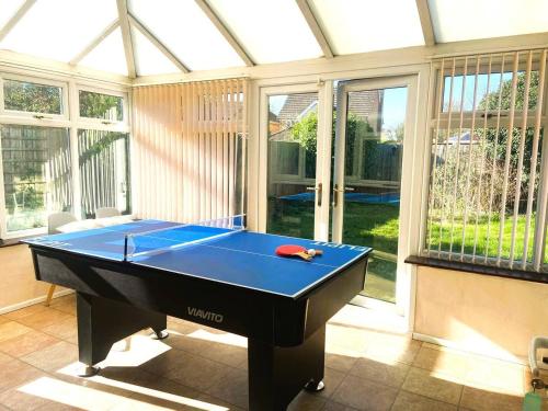 a ping pong table in a room with a pool table at Large detached House in ELY with FREE private parking in Ely