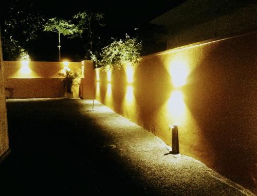 a group of lights on a wall at night at Bilin Villa in Ahangama