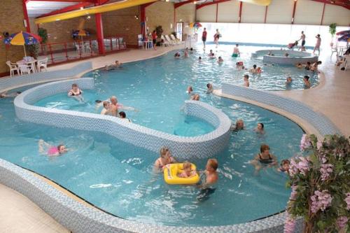 a group of people in a swimming pool at Willerby Castleton,Camber Sands- sleeps 6 Entertainment passes not included in Camber