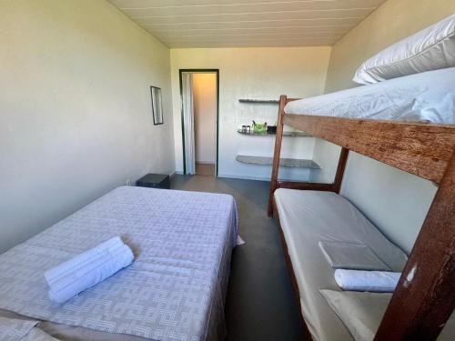 a small room with two bunk beds and a hallway at Paraíso Escondido Beach House! in Goiana