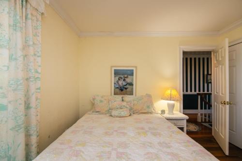 a bedroom with a bed and a lamp and a window at Marsa's Place in Edisto Island