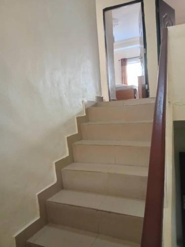 a stairway with a mirror on the wall and a stair case at Home Away from Home - Gowon Estate near Gemade, Ipaja, Lagos in Lagos