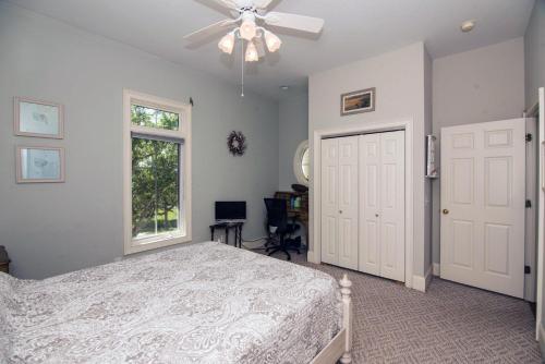 a bedroom with a bed and a ceiling fan at Moonrise Point in Edisto Island
