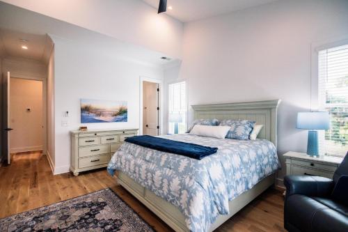 a bedroom with a bed and a dresser and a couch at Glory Be in Edisto Island