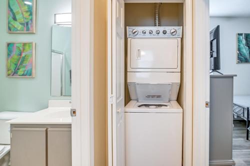 a kitchen with a washer and dryer in a room at 4 Mi to Ocean Breezy Golf Condo in Myrtle Beach! in Myrtle Beach