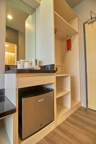 a kitchen with a sink and a dishwasher at Cebu Hotel Plus in Cebu City