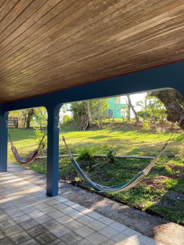 a hammock in a park under a bridge at Finca Marbella in San Ramón