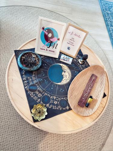 a wooden table with books and items on it at Artists' Nest in Marsaskala
