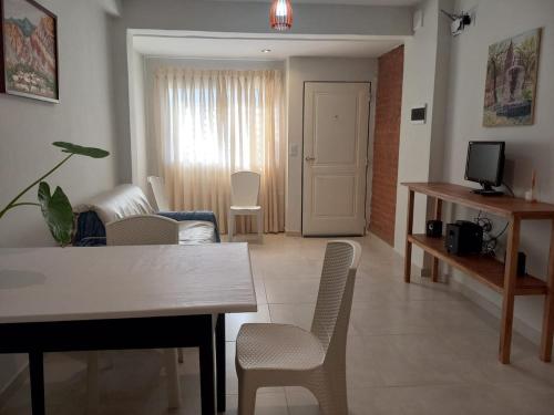 a living room with a table and chairs and a television at Domus B1 in Posadas