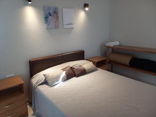 a bedroom with a bed with two pillows on it at Domus B1 in Posadas