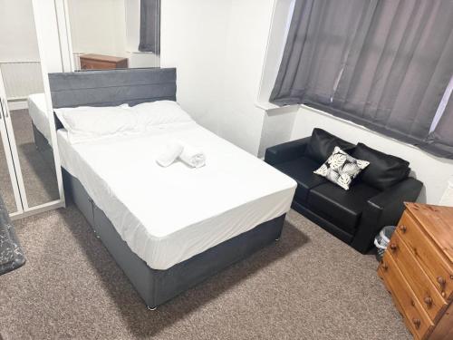 a bed and a chair in a room at Serene Suite Rooms 1 - 5 in Southampton