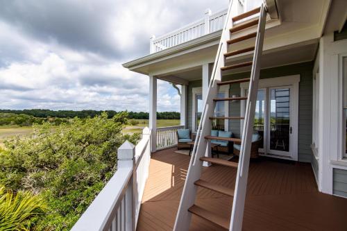 a spiral staircase on a house with a porch at Tequila Sunset in Edisto Island