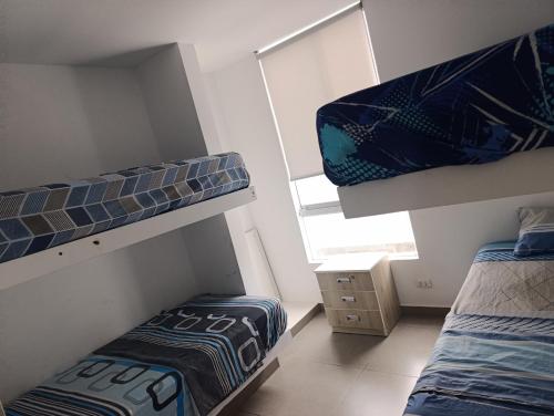 Ένα ή περισσότερα κρεβάτια σε δωμάτιο στο casa en playa de condominio mikonos