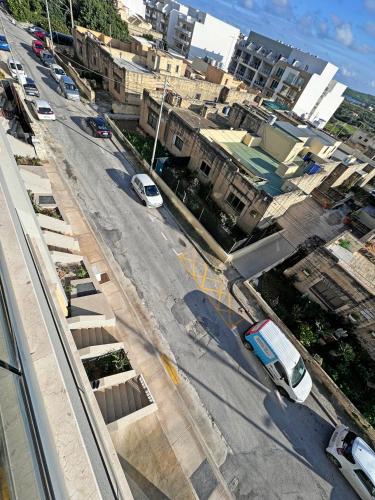 an aerial view of a city street with cars parked at Artists' Nest in Marsaskala