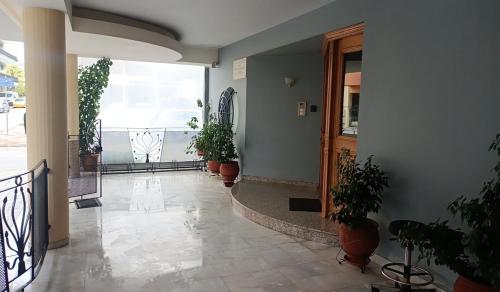 a hallway with potted plants in a building at Country Escape in Volos