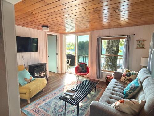 a living room with a couch and a fireplace at Lakefront Hot Tub Getaway in Traverse City