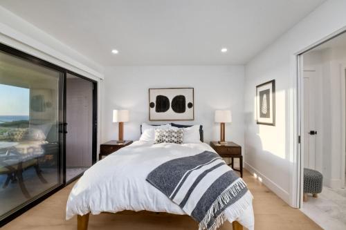 a bedroom with a bed and a glass wall at 597 S Sierra Avenue - Unit 68 in Solana Beach