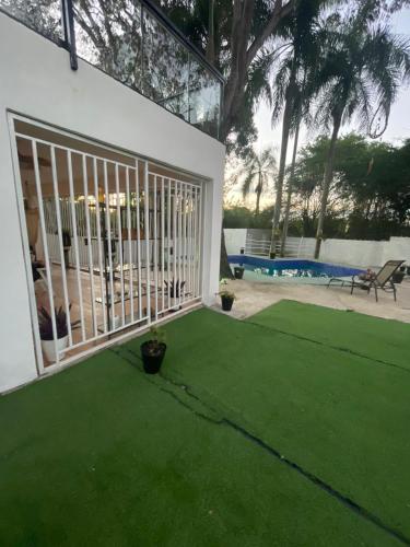 a yard with green grass and a fence at Villa Tulum in San Cristóbal
