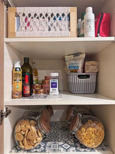 a pantry filled with lots of different types of food at Artists' Nest in Marsaskala