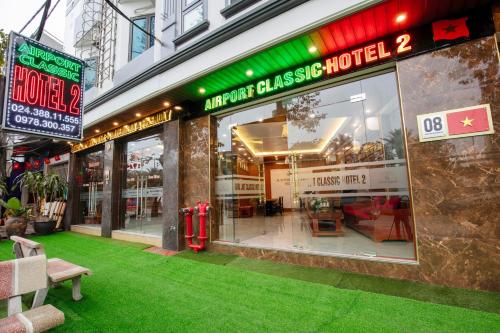 a store front with green grass in front of it at Airport Classic Hotel 2 in Sóc Sơn