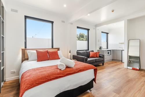 a bedroom with a large bed and a living room at Canterbury Street Apartments in Casino