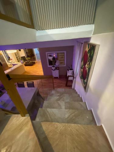 a living room with a staircase and a painting on the wall at Villa Tulum in San Cristóbal