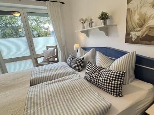 a bedroom with a bed with pillows on it at 1-bedroom apartment Meeresrauschen in Schönberg