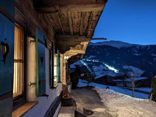 a building with a view of a snowy mountain at Holiday home Chalet Weberer in Stummerberg