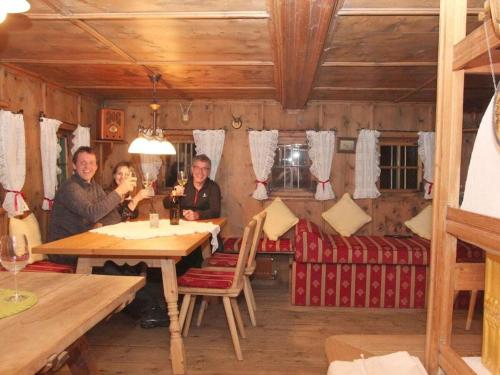 a group of people sitting at a table in a room at Holiday home Chalet Weberer in Stummerberg