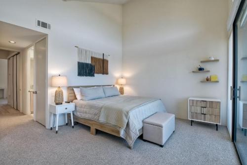 a bedroom with a bed and a table and a lamp at 916 Sea Lane in Encinitas