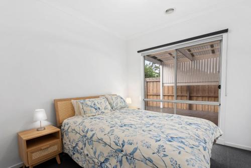 a bedroom with a bed and a window at Latte's Nest in Point Lonsdale