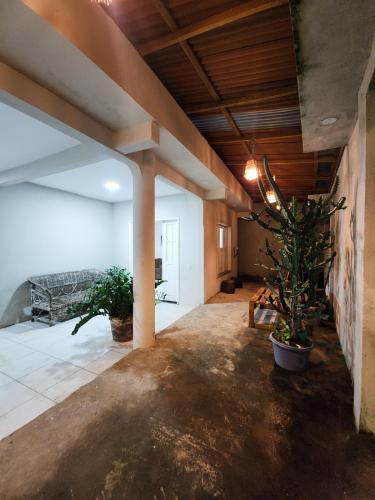 a large living room with a couch and potted plants at Pousada Cactus in Barreirinhas