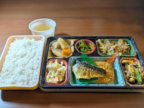 a tray of food with rice and seafood and a drink at Kochi Green Hotel Harimayabashi in Kochi