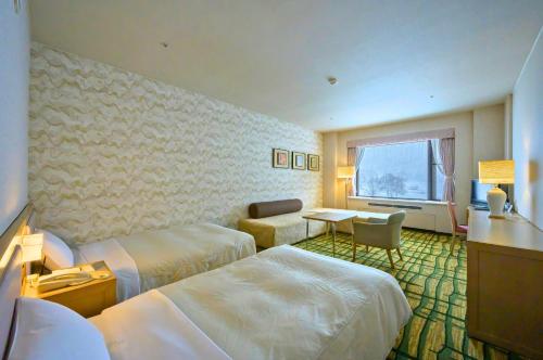 Postel nebo postele na pokoji v ubytování Hotel Tangram