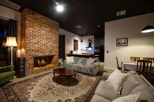 a living room with a couch and a fireplace at Monument House in Mount Barker