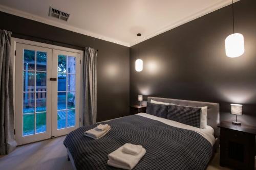 a bedroom with a bed with two towels on it at Monument House in Mount Barker