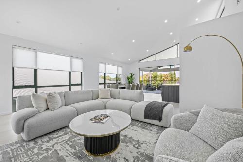 a living room with a couch and a table at Luxury Designer Retreat - Modern, Entertainer in Orange