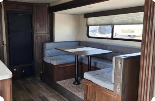 a dining area in an rv with a table at Sleepyheadz Campers and Tents LLC in Bloomington