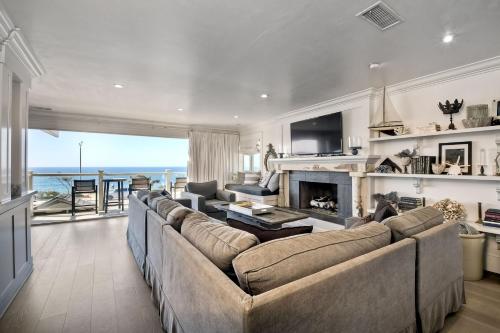 a living room with a couch and a fireplace at 3636 Carlsbad Blvd - Upper in Carlsbad
