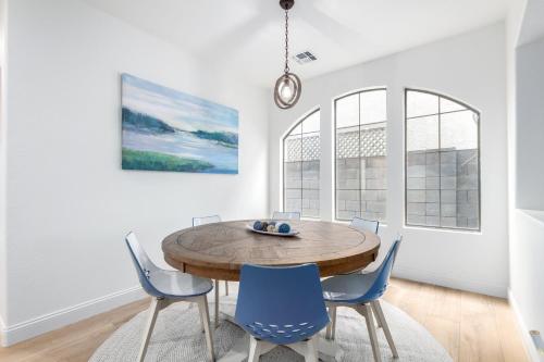 a dining room with a wooden table and blue chairs at San Michelle Luxury Escape Mesa Pr1348 in Mesa