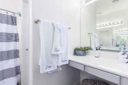 a bathroom with white towels and a sink and a mirror at San Michelle Luxury Escape Mesa Pr1348 in Mesa