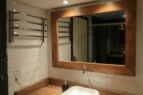 a bathroom with a mirror and a sink at Pousada Província in Lavras Novas