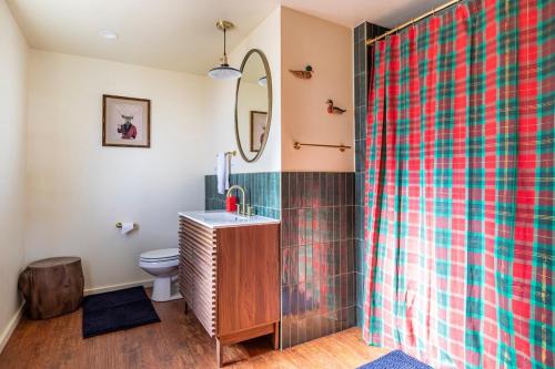 a bathroom with a shower with a sink and a toilet at Chair 9 Chalet in Big Bear Lake