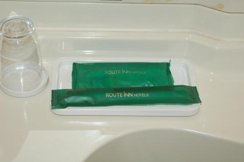 a plastic container with a tube of toothpaste and a bottle of water at Hotel Route-Inn Shimizu Inter in Shizuoka