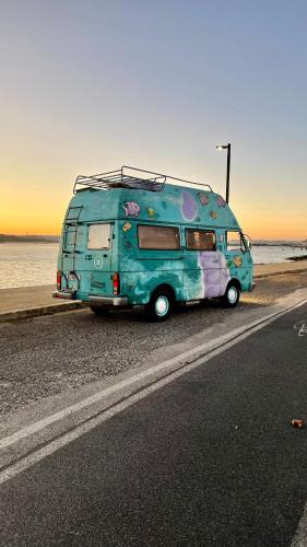 a blue van parked on the side of a road at Campervan Dory in Lisbon