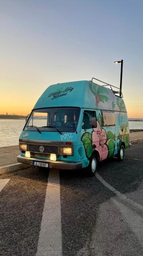 a van parked in a parking lot next to the ocean at Campervan Dory in Lisbon